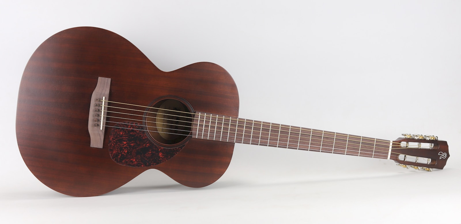 brown acoustic guitar on white background